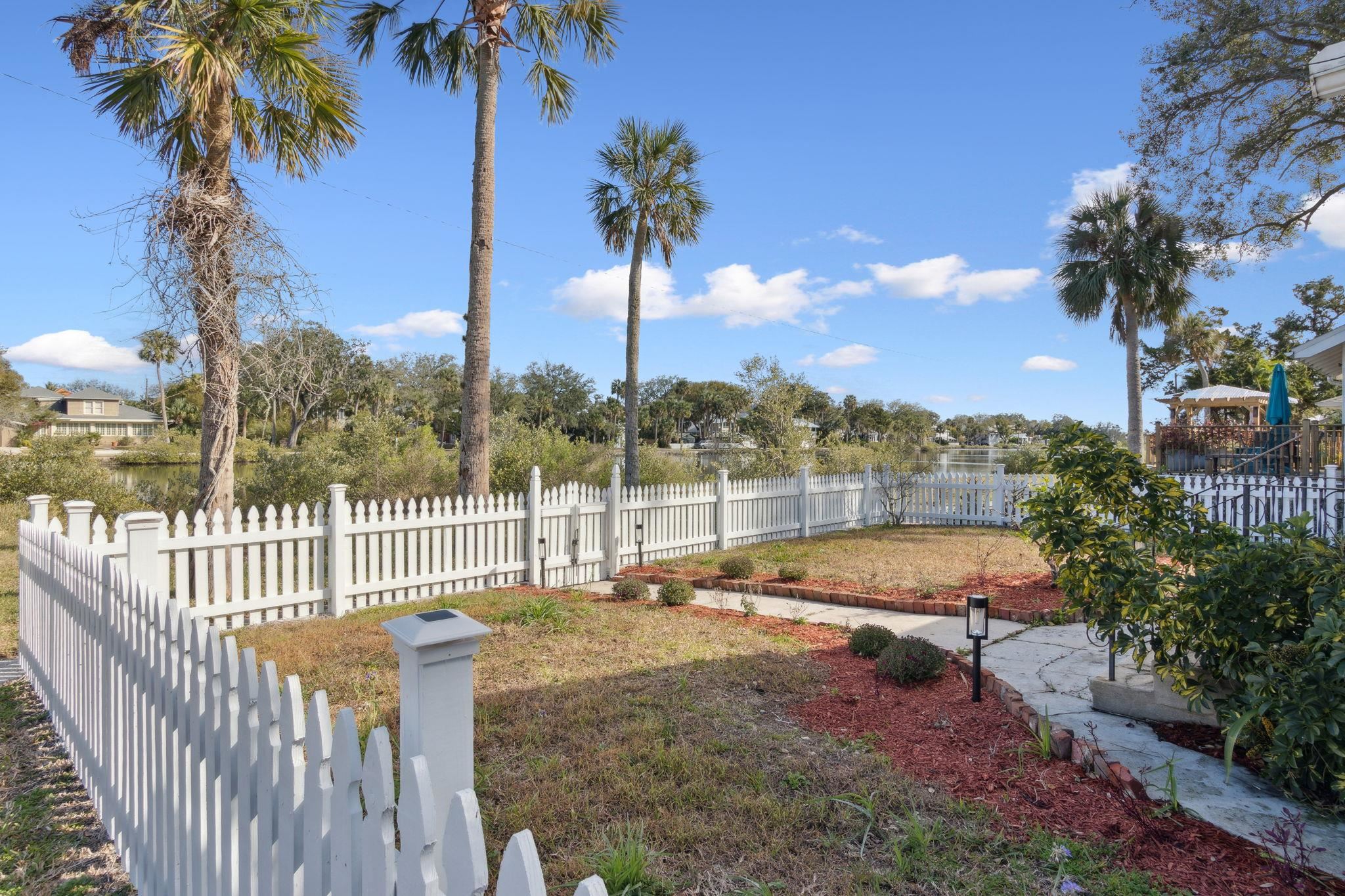 67 Park Place St. Augustine, FL 32084 - Photo 6 of 69 a view of a swimming pool with a garden and patio