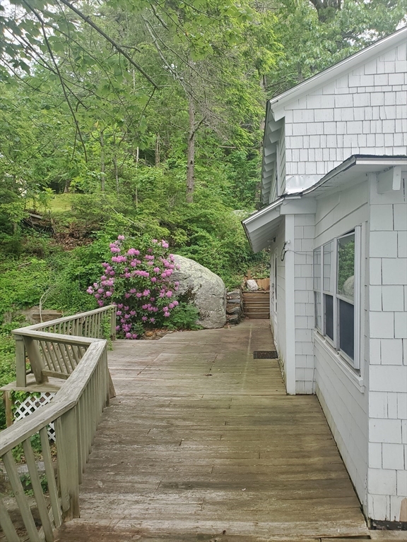 288 Clark Rd Extension Sturbridge, MA 01518 - Photo 2 of 14 a view of a balcony with wooden floor and fence and a potted plant