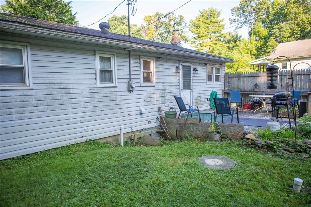 8657 South Loop Road Slatington, PA 18080 - Photo 22 of 32 A grassy yard area borders the back siding of the home near the rear deck.