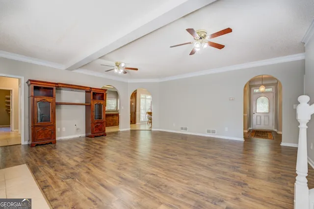 a big room with wooden floors and windows
