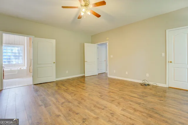 a view of a kitchen with furniture and wooden floor