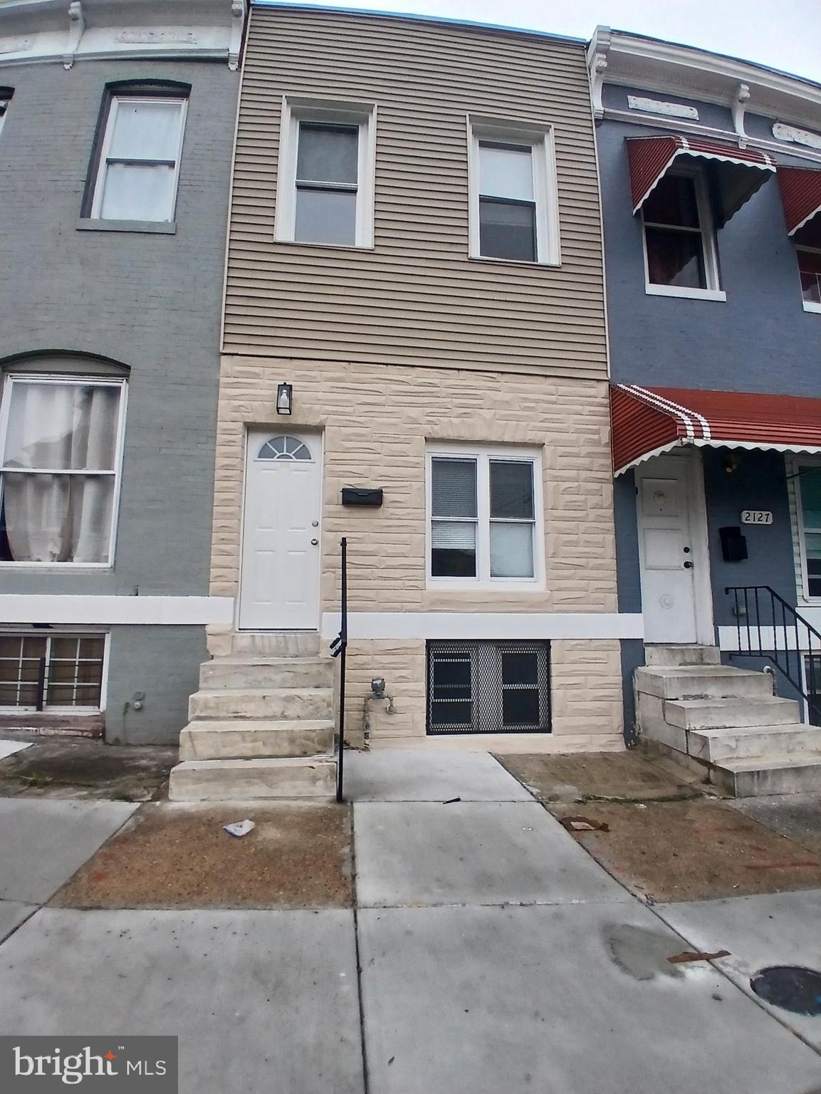 2129 Federal Street Baltimore, MD 21213 - Photo 13 of 27 a front view of a house with a road