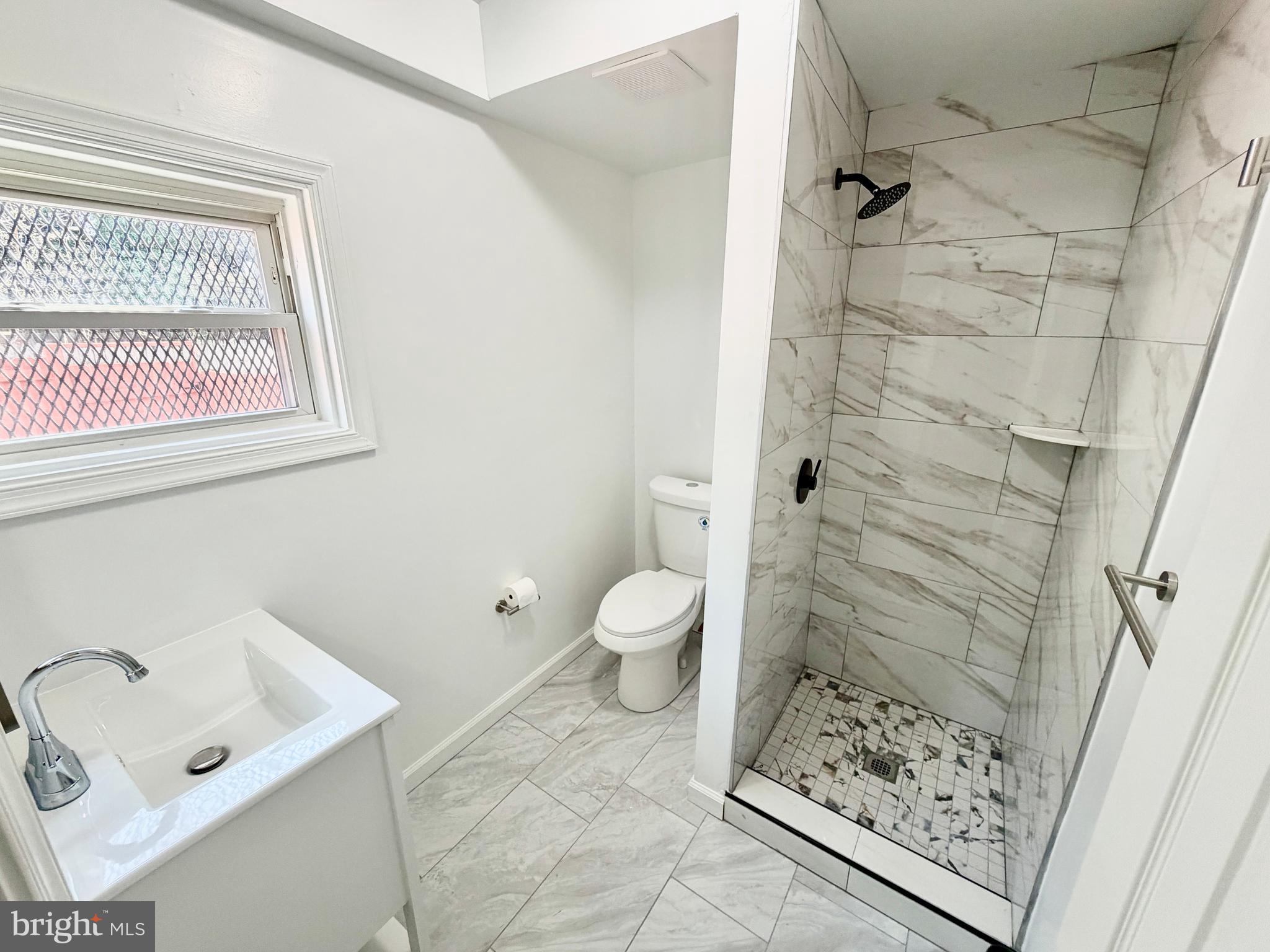 2129 Federal Street Baltimore, MD 21213 - Photo 16 of 27 a bathroom with a sink toilet and shower