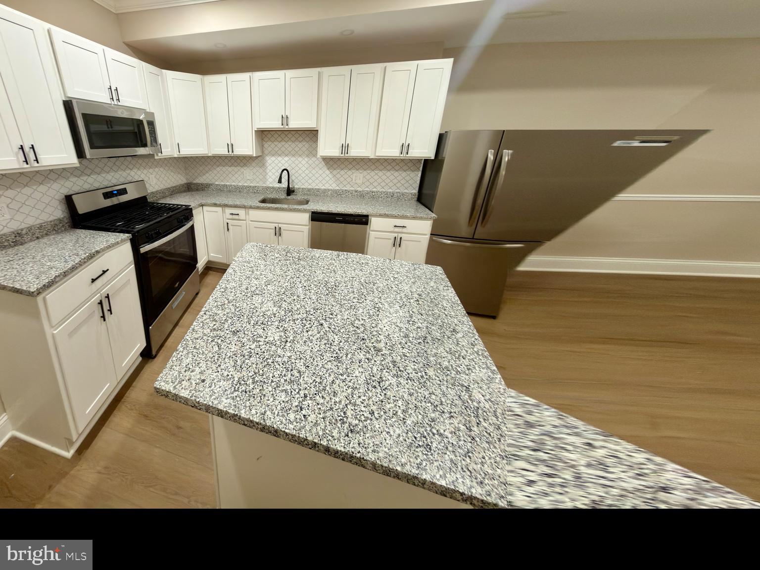 2129 Federal Street Baltimore, MD 21213 - Photo 23 of 27 a kitchen with stainless steel appliances granite countertop a sink stove and refrigerator