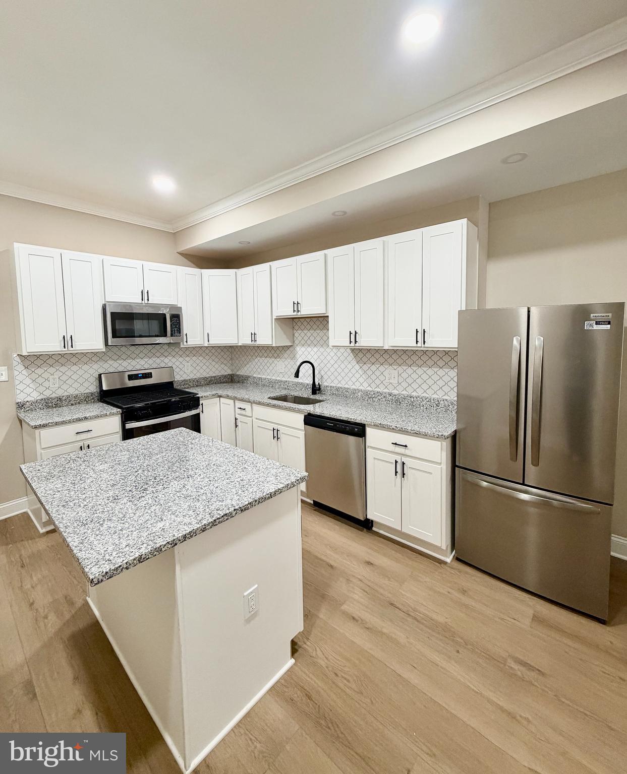 2129 Federal Street Baltimore, MD 21213 - Photo 6 of 27 a kitchen with stainless steel appliances granite countertop a refrigerator sink and cabinets
