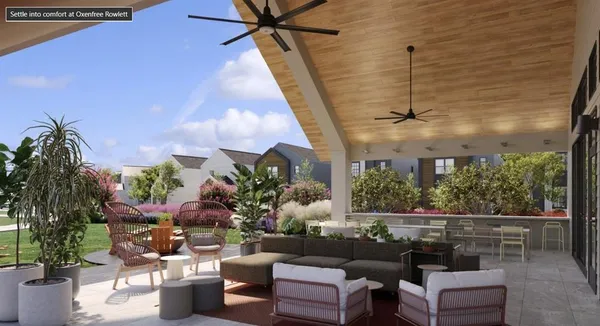 a view of a house with backyard and sitting area