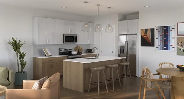 a kitchen with stainless steel appliances a stove a refrigerator and a dining table