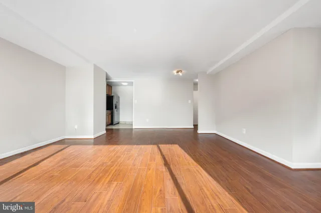 a view of an empty room and wooden floor