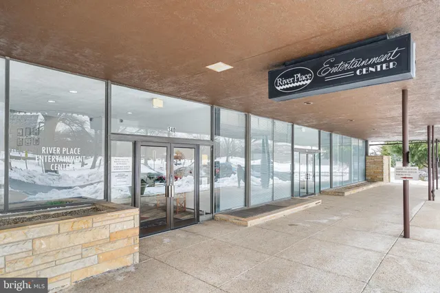 a backyard of a house with barbeque oven table and chairs