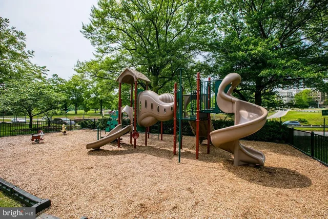 a backyard of a house with wooden floor and outdoor seating