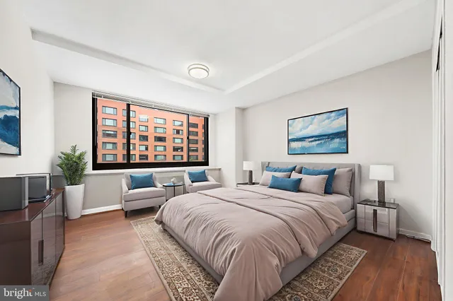 a spacious bedroom with a large bed and a large window