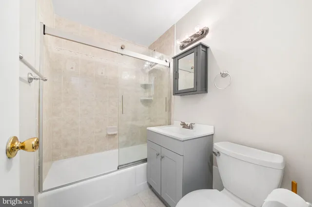 a bathroom with a toilet sink and shower