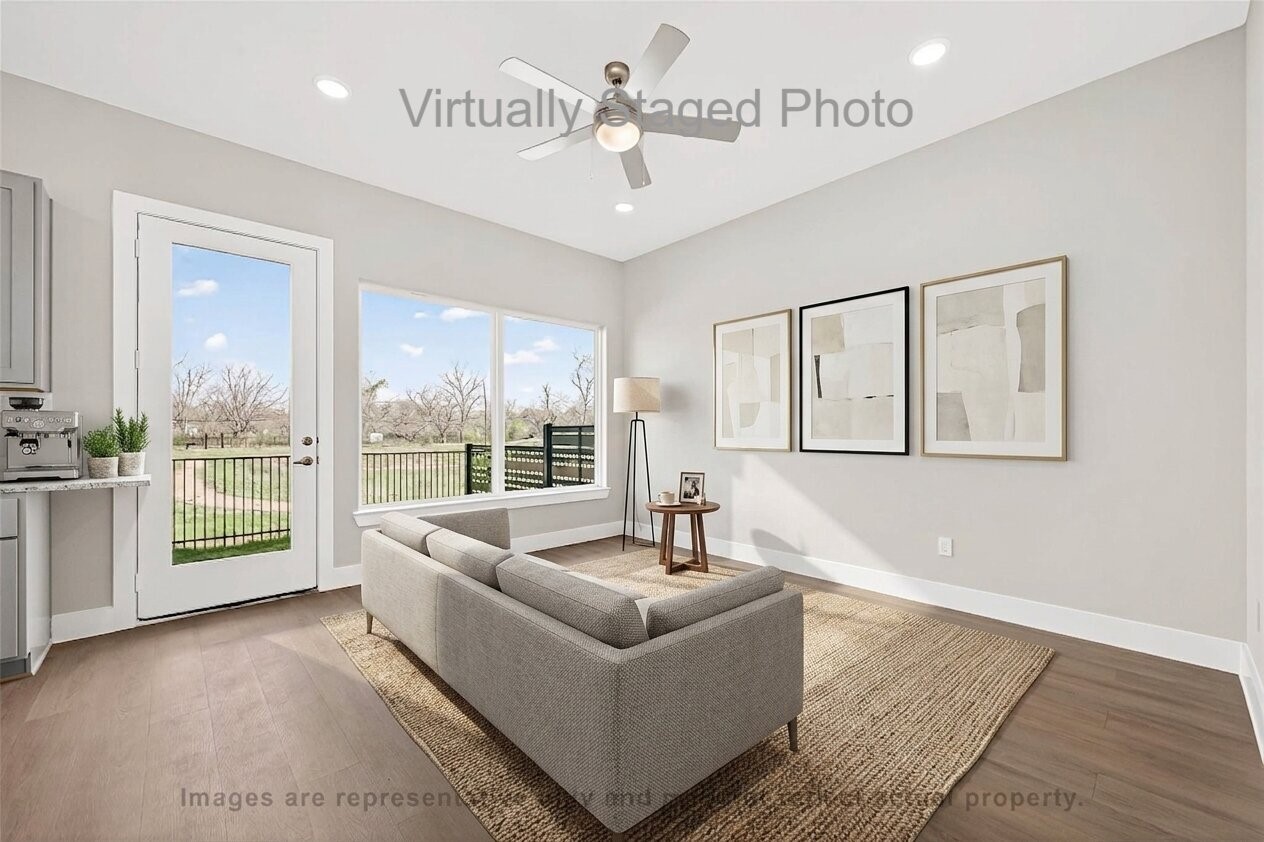 10719 Mason Road, Unit 15 Richmond, TX 77406 - Photo 12 of 50 Virtual Staging - Modern sitting area featuring a gray sofa, a large woven rug, and three framed artworks hanging near a glass door