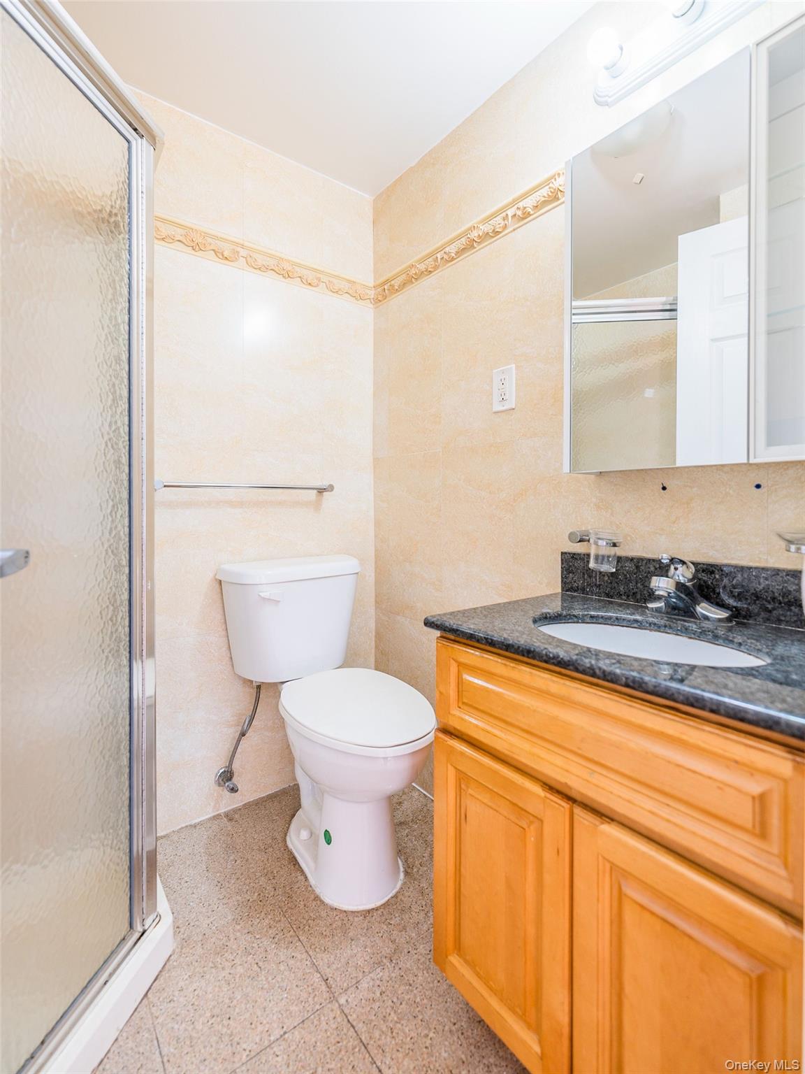 112-26 38th Avenue, Unit 4A Queens, NY 11368 - Photo 11 of 18 a bathroom with a granite countertop sink mirror vanity and toilet