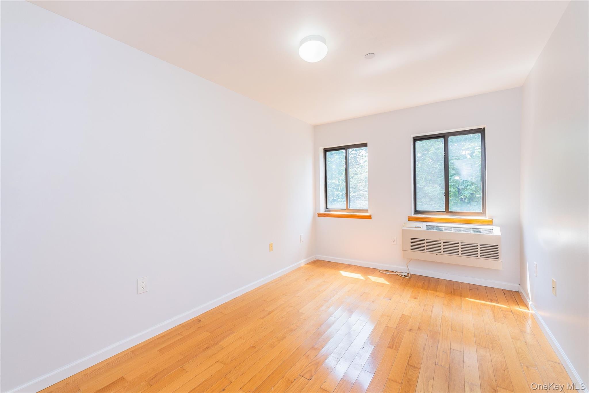 112-26 38th Avenue, Unit 4A Queens, NY 11368 - Photo 13 of 18 an empty room with windows