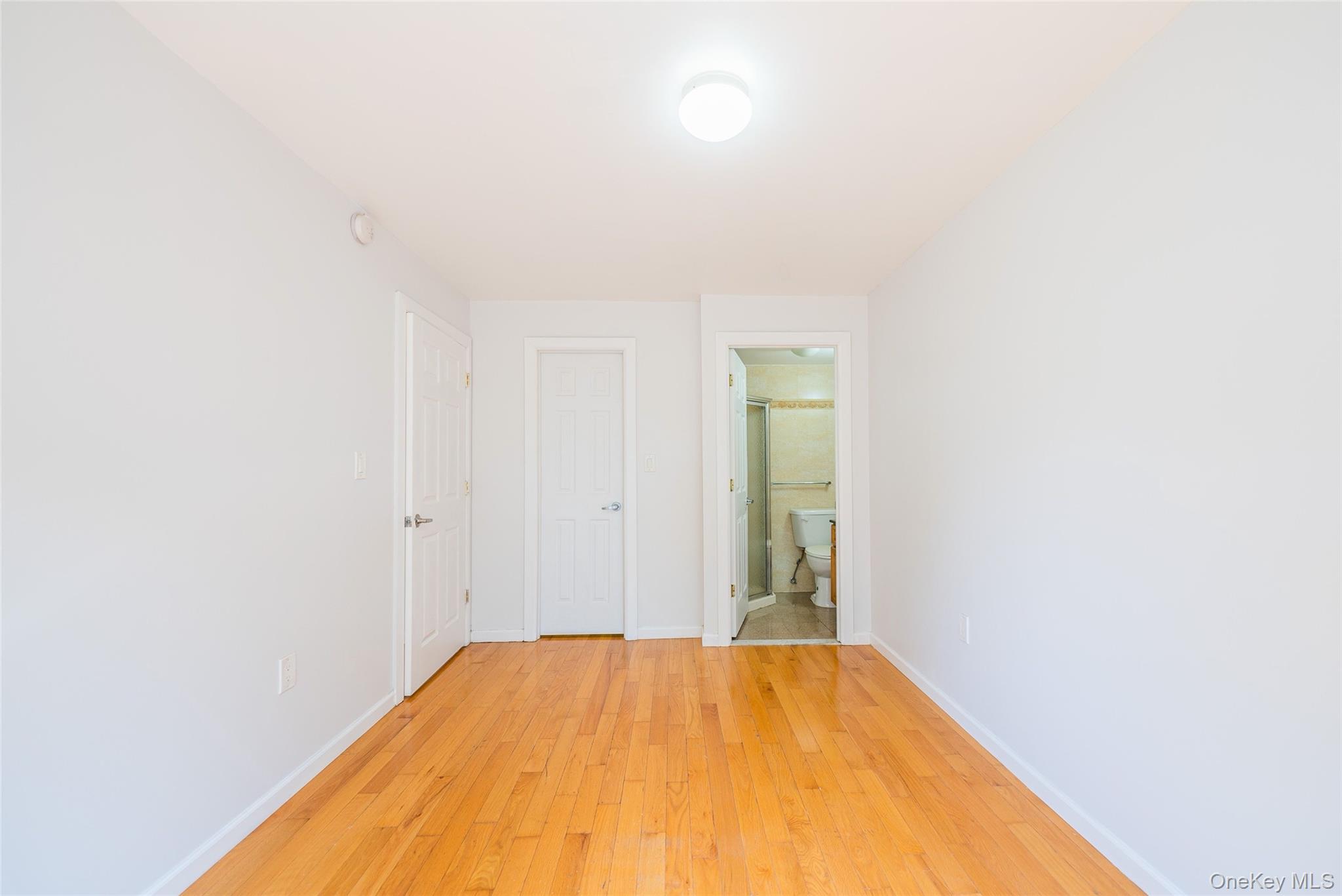 112-26 38th Avenue, Unit 4A Queens, NY 11368 - Photo 16 of 18 a view of a room with empty room and wooden floor