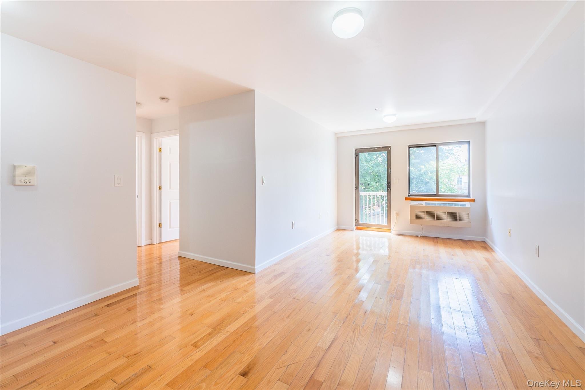 112-26 38th Avenue, Unit 4A Queens, NY 11368 - Photo 6 of 18 wooden floor in an empty room with a window