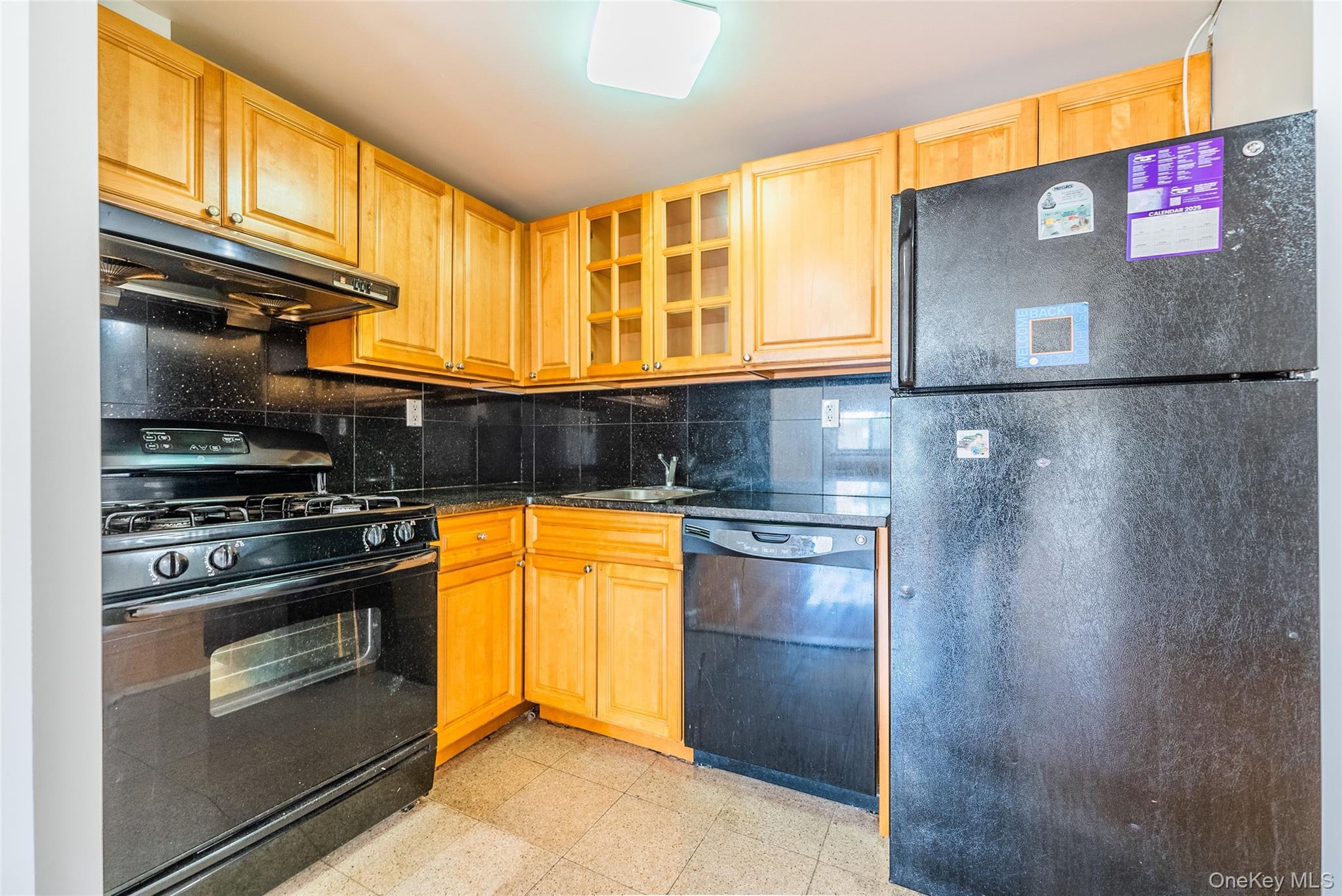 112-26 38th Avenue, Unit 4A Queens, NY 11368 - Photo 9 of 18 a kitchen with stainless steel appliances granite countertop a refrigerator and a stove