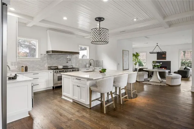 a kitchen with granite countertop a sink and stainless steel appliances
