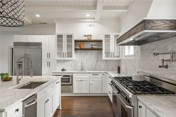 a living room with furniture chandelier and a window