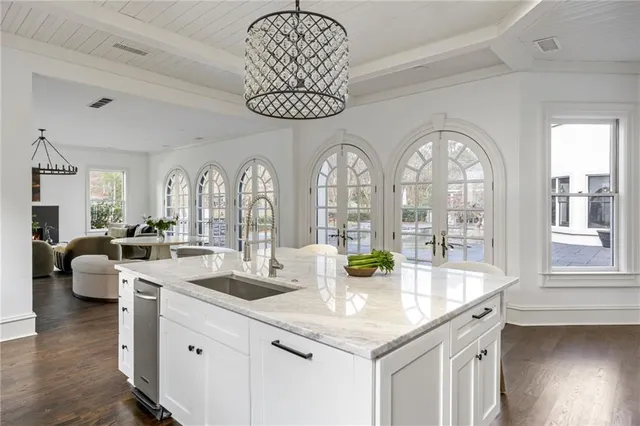 a living room with furniture a fireplace and a large window