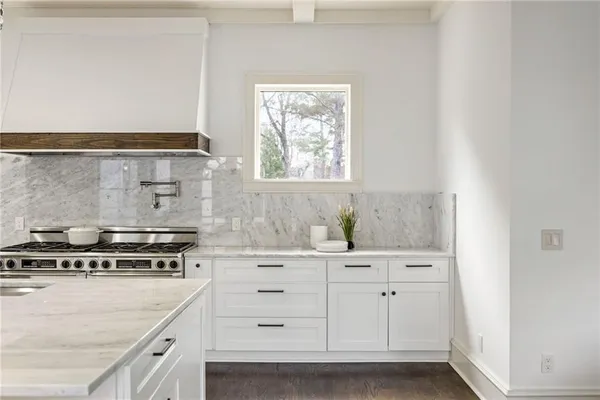 a living room with furniture a chandelier and a large window