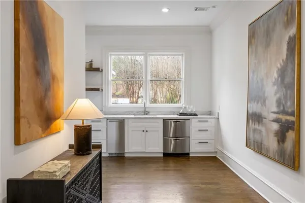 a living room with furniture chandelier and a window