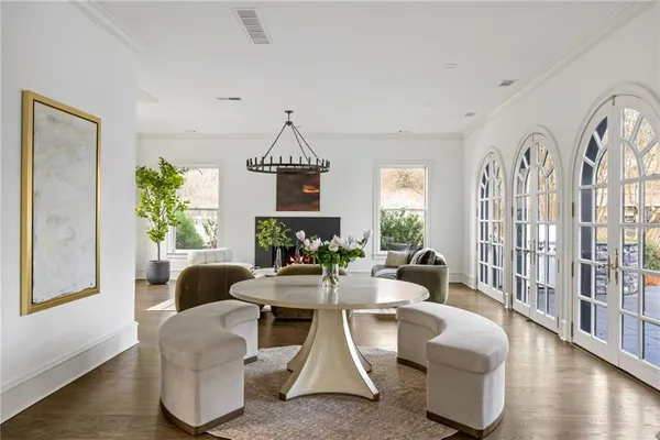 a living room with fireplace furniture and a chandelier
