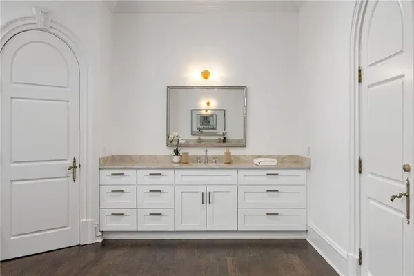 an aerial view of a house with swimming pool and large trees