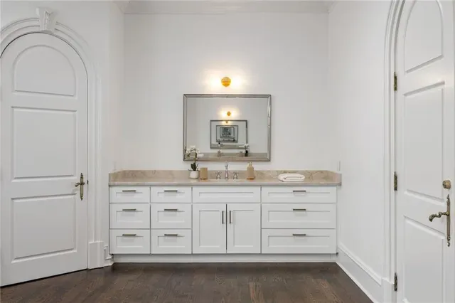 an aerial view of a house with swimming pool and large trees