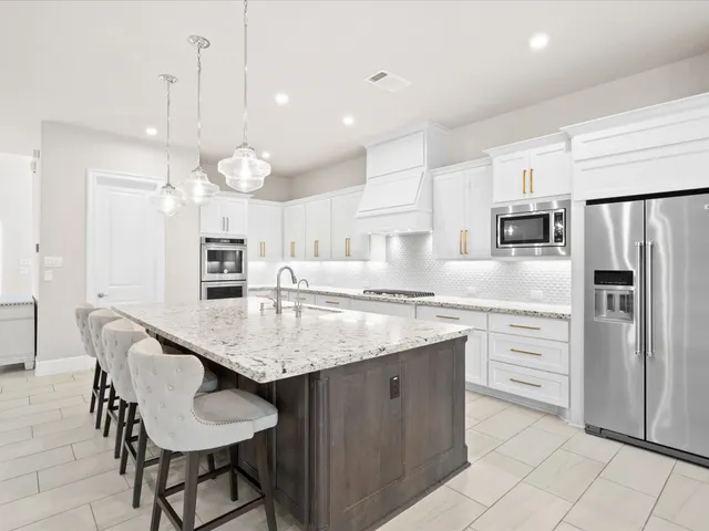 a kitchen with sink stove and cabinets