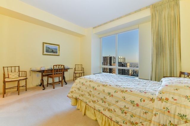 a bedroom with a bed and a table in it