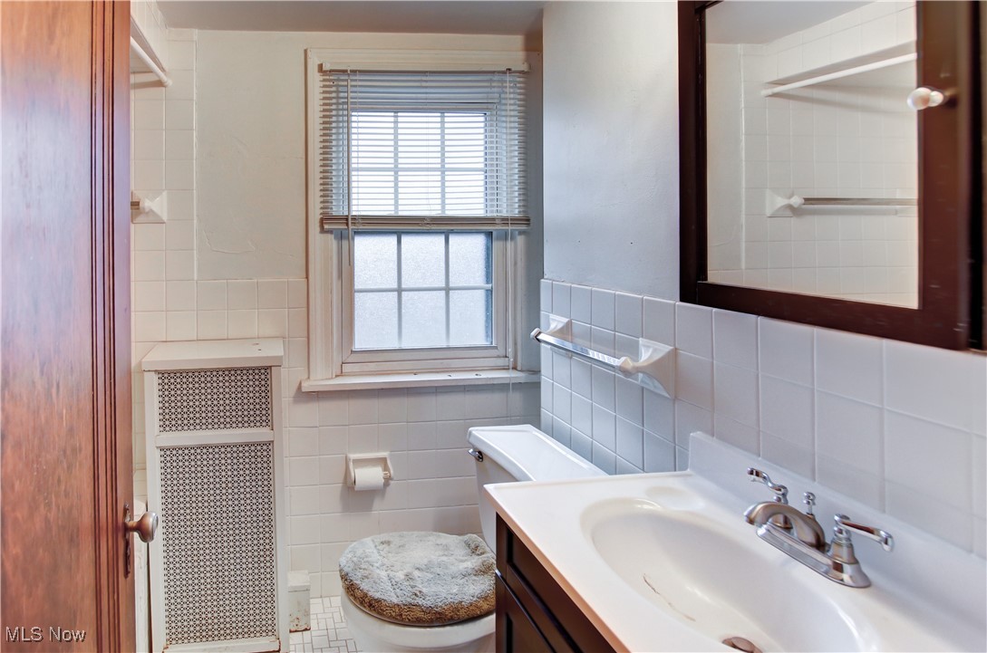 17800 Winslow Road Beachwood, OH 44122 - Photo 26 of 31 Bathroom with radiator heating unit, vanity, tile walls, and toilet