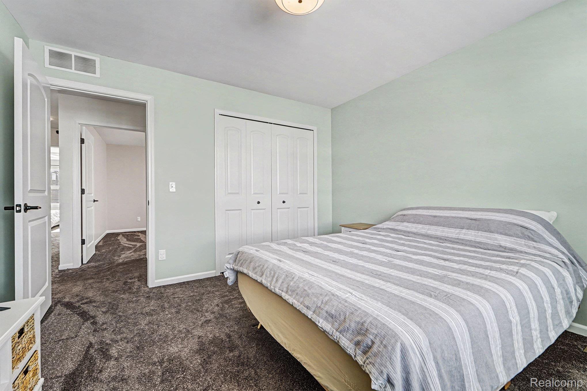 2471 Massoit Road Royal Oak, MI 48073 - Photo 28 of 49 Bedroom featuring dark colored carpet and a closet