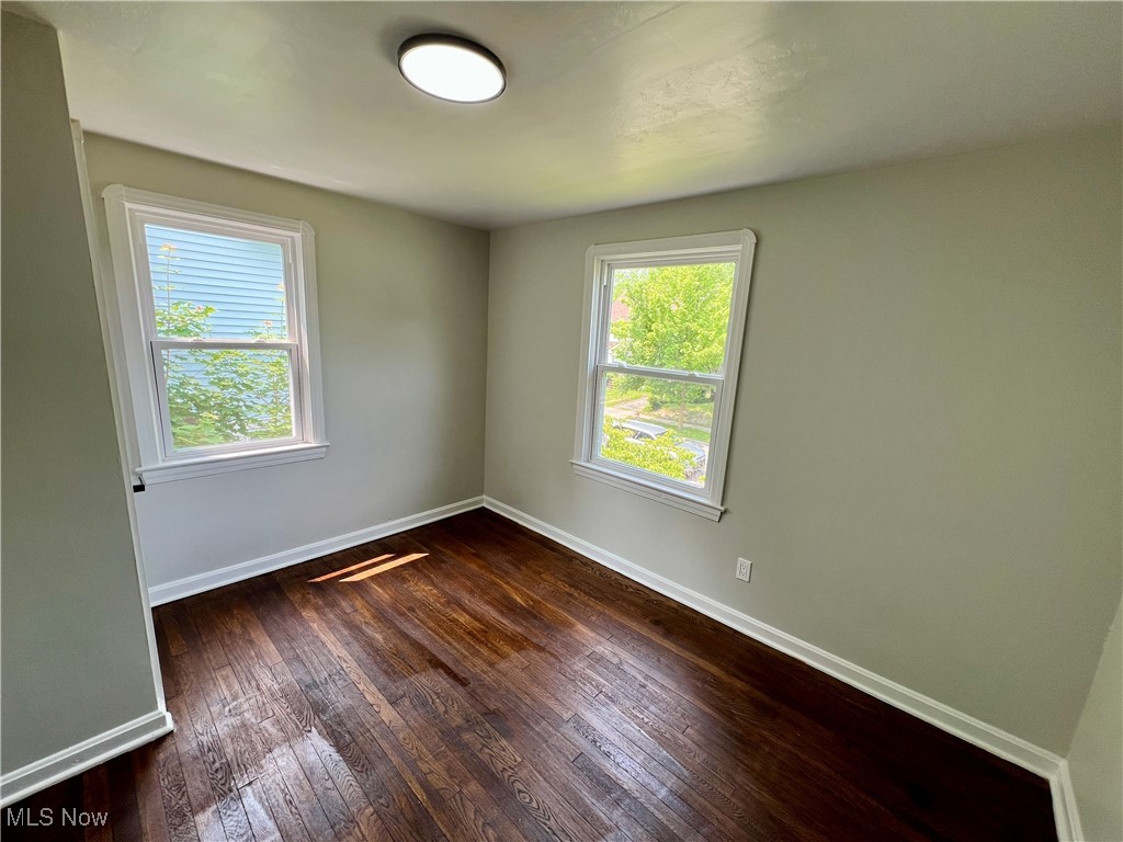 887 Yellowstone Road Cleveland Heights, OH 44121 - Photo 20 of 35 Empty room featuring baseboards and dark wood-style floors