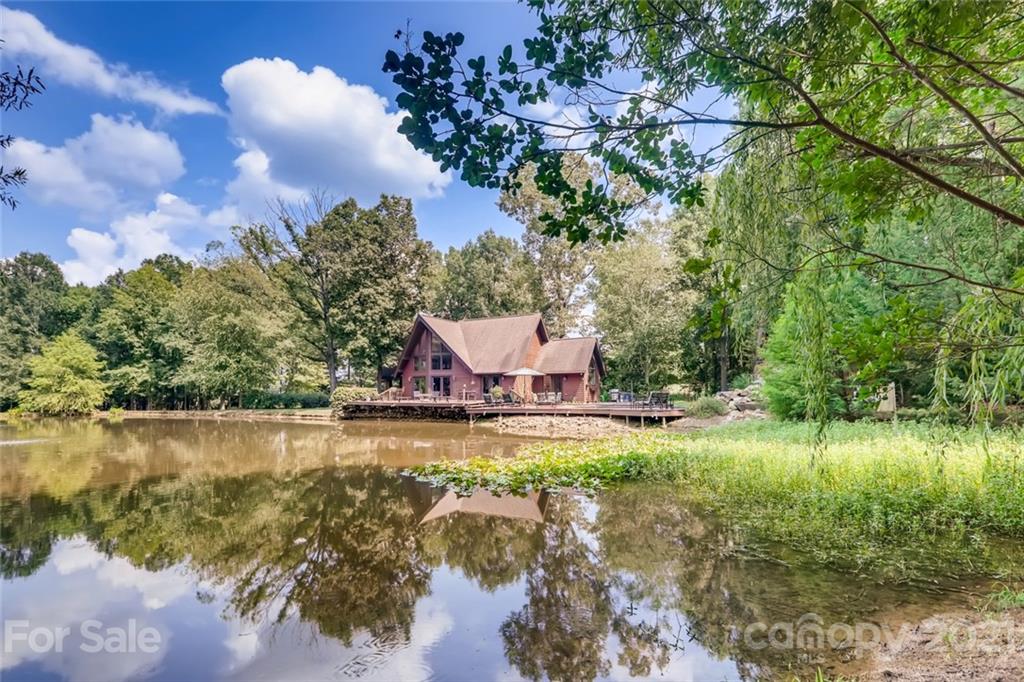 5508 Griffith Road Monroe, NC 28112 - Photo 11 of 48 a view of a lake with a house in the background