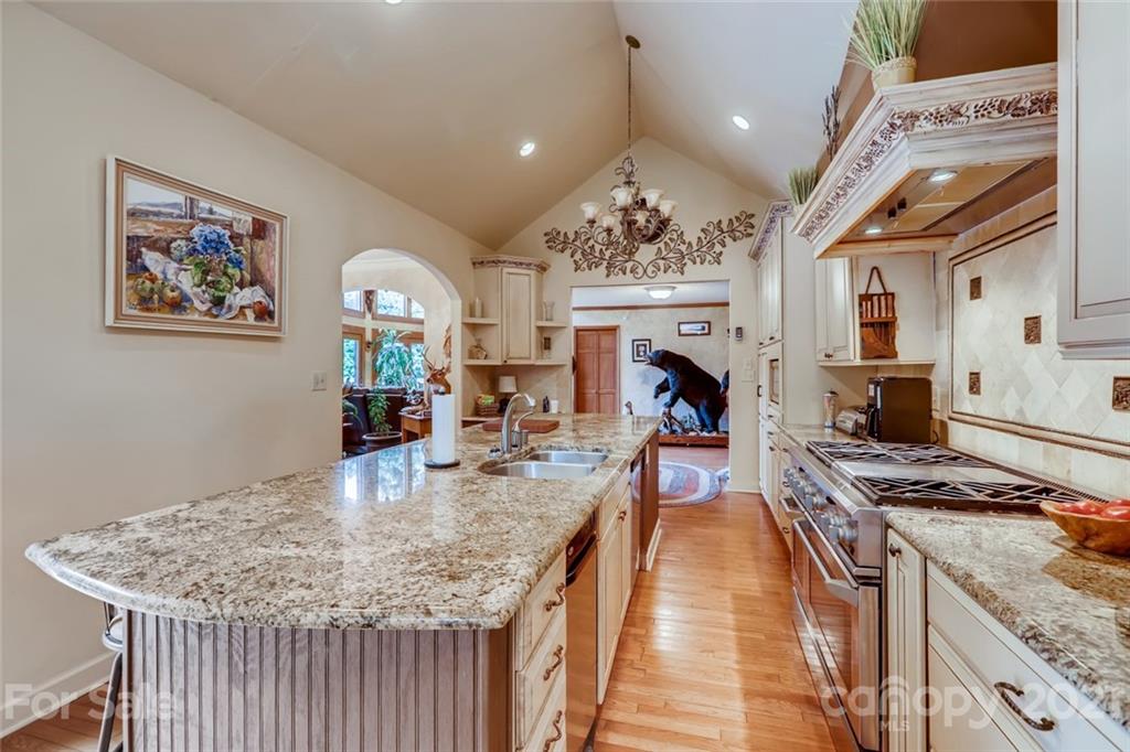5508 Griffith Road Monroe, NC 28112 - Photo 20 of 48 a kitchen with stainless steel appliances granite countertop a stove and a wooden floors