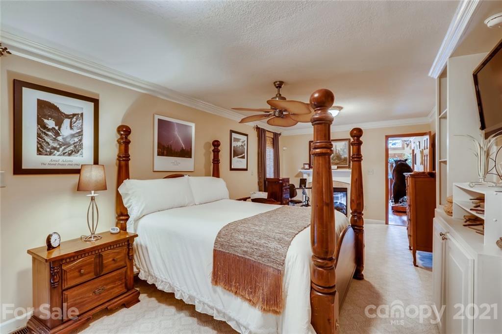 5508 Griffith Road Monroe, NC 28112 - Photo 22 of 48 a spacious bedroom with a bed a ceiling fan and a dresser