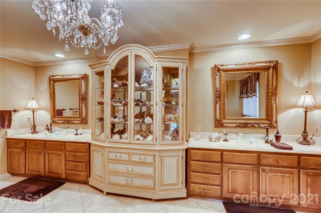 5508 Griffith Road Monroe, NC 28112 - Photo 24 of 48 a bathroom with a double vanity sink a mirror a and a shower