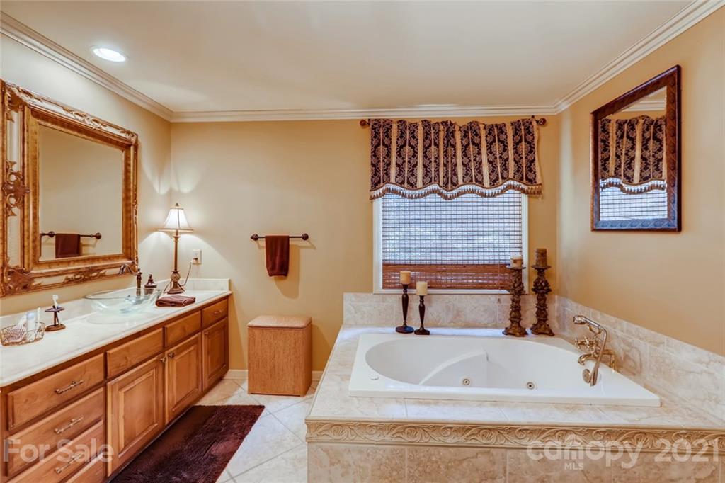 5508 Griffith Road Monroe, NC 28112 - Photo 26 of 48 a bathroom with a double vanity sink and a bathtub