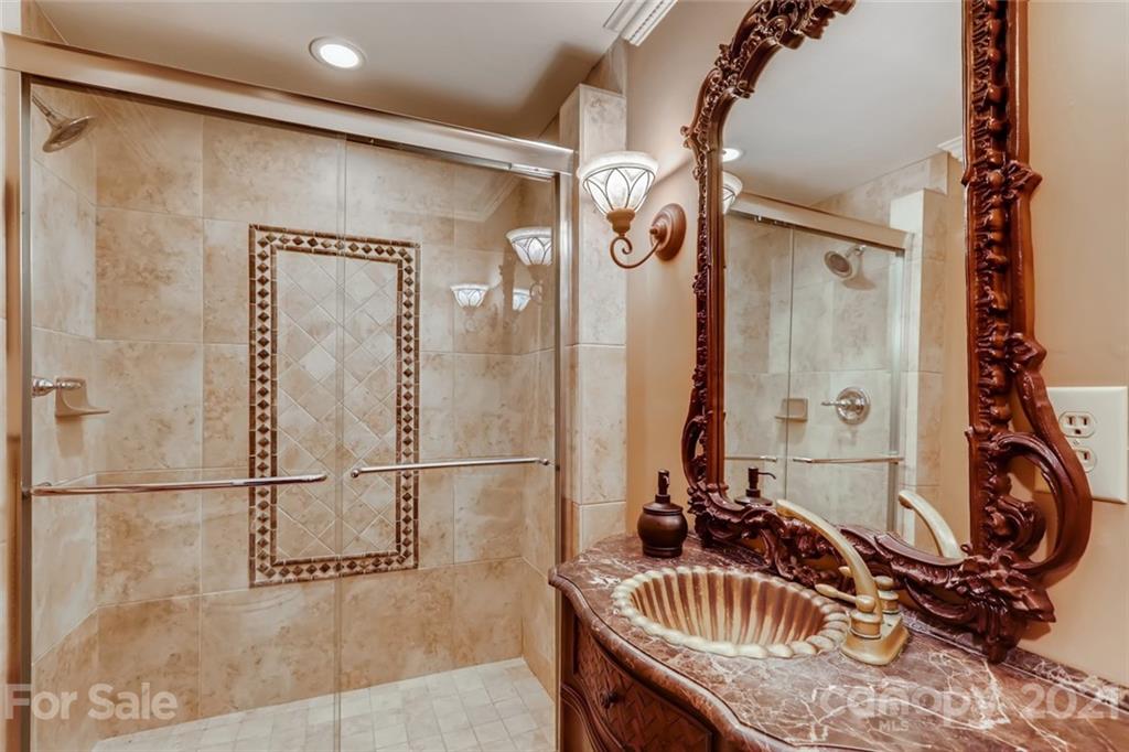 5508 Griffith Road Monroe, NC 28112 - Photo 28 of 48 a bathroom with a granite countertop sink and a mirror