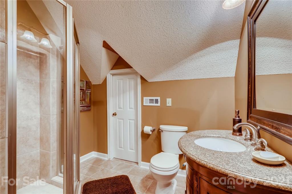 5508 Griffith Road Monroe, NC 28112 - Photo 33 of 48 a bathroom with a granite countertop sink and a mirror