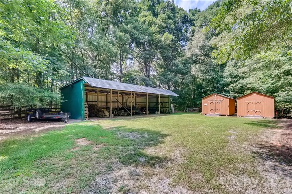 5508 Griffith Road Monroe, NC 28112 - Photo 41 of 48 a front view of a house with a garden and trees