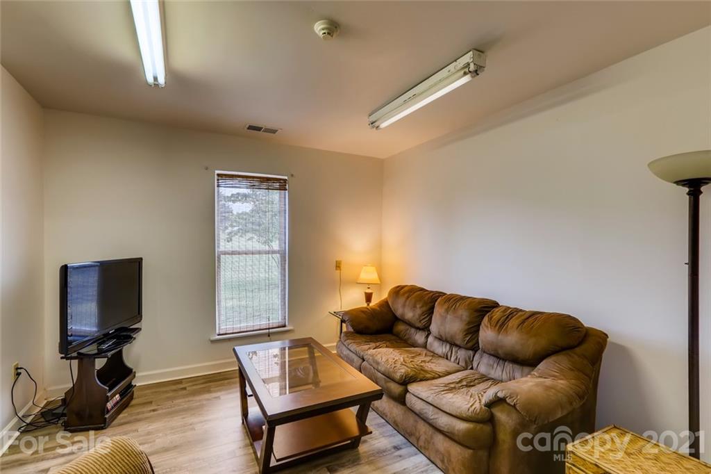 5508 Griffith Road Monroe, NC 28112 - Photo 45 of 48 a living room with furniture and a flat screen tv