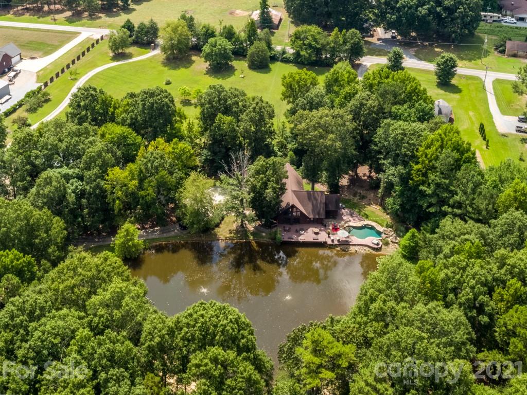 5508 Griffith Road Monroe, NC 28112 - Photo 7 of 48 a view of a lake with a house