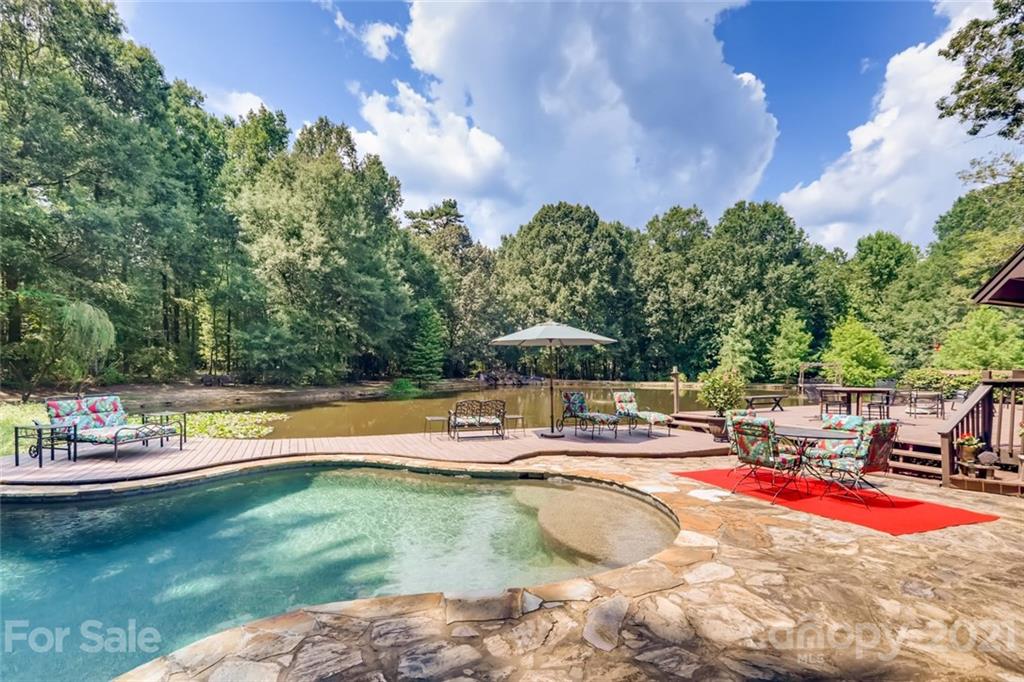 5508 Griffith Road Monroe, NC 28112 - Photo 8 of 48 a view of a swimming pool with an outdoor space and seating area
