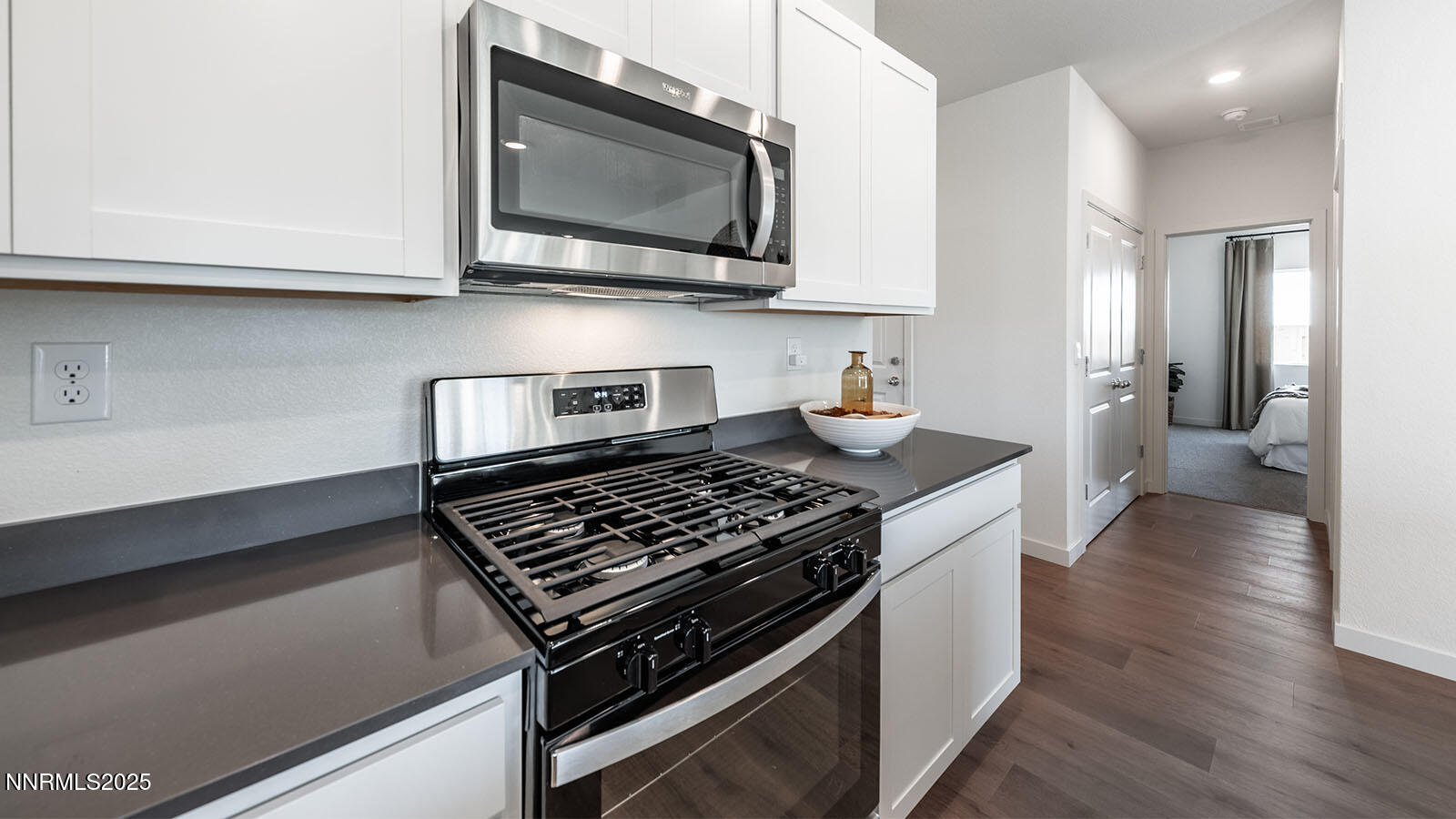 4536 Mifflin Street, Unit LOT #5 Fernley, NV 89408 - Photo 11 of 25 a kitchen with stainless steel appliances granite countertop a stove and a microwave