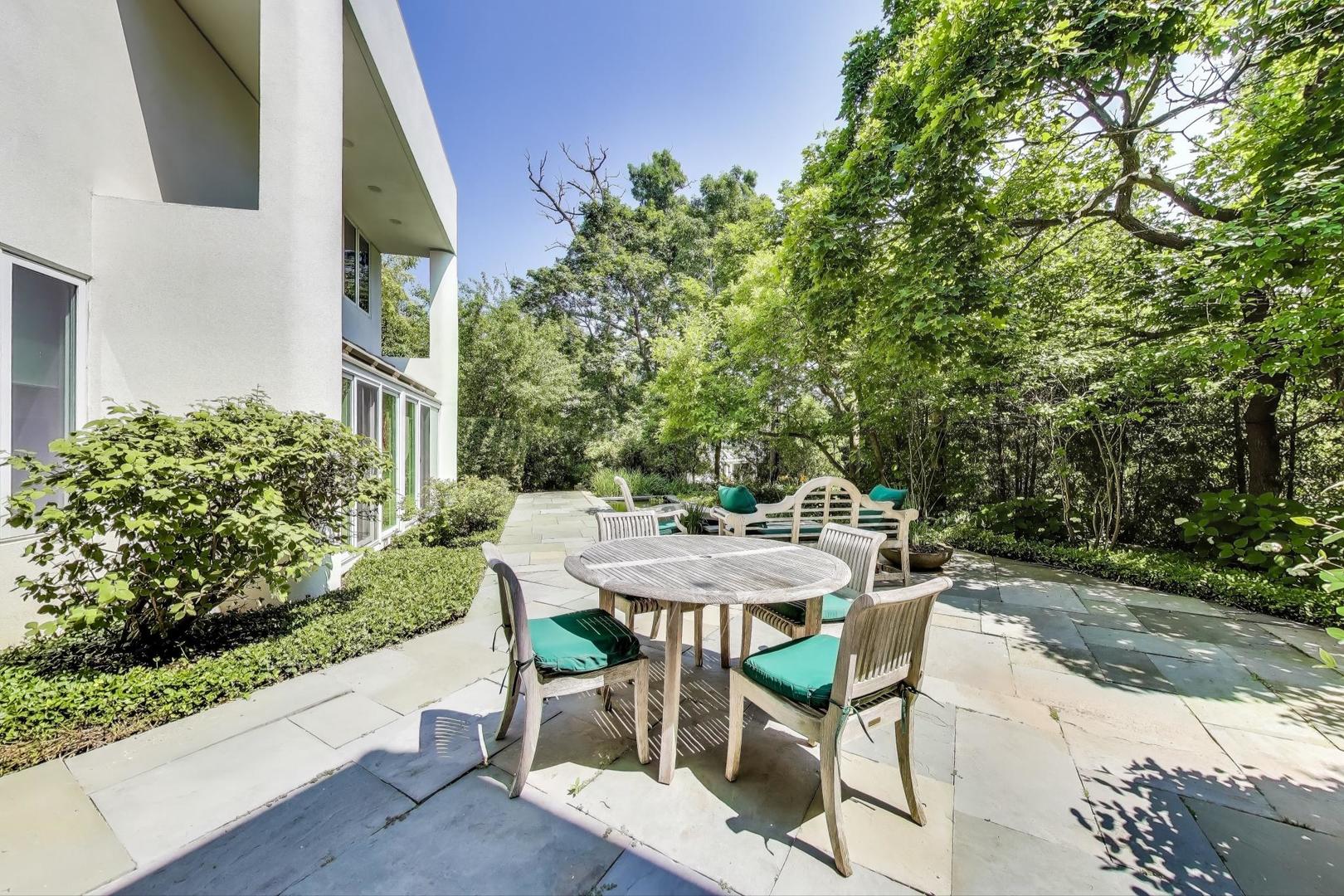 90 Riparian Road Highland Park, IL 60035 - Photo 58 of 76 a view of a patio with table and chairs and potted plants