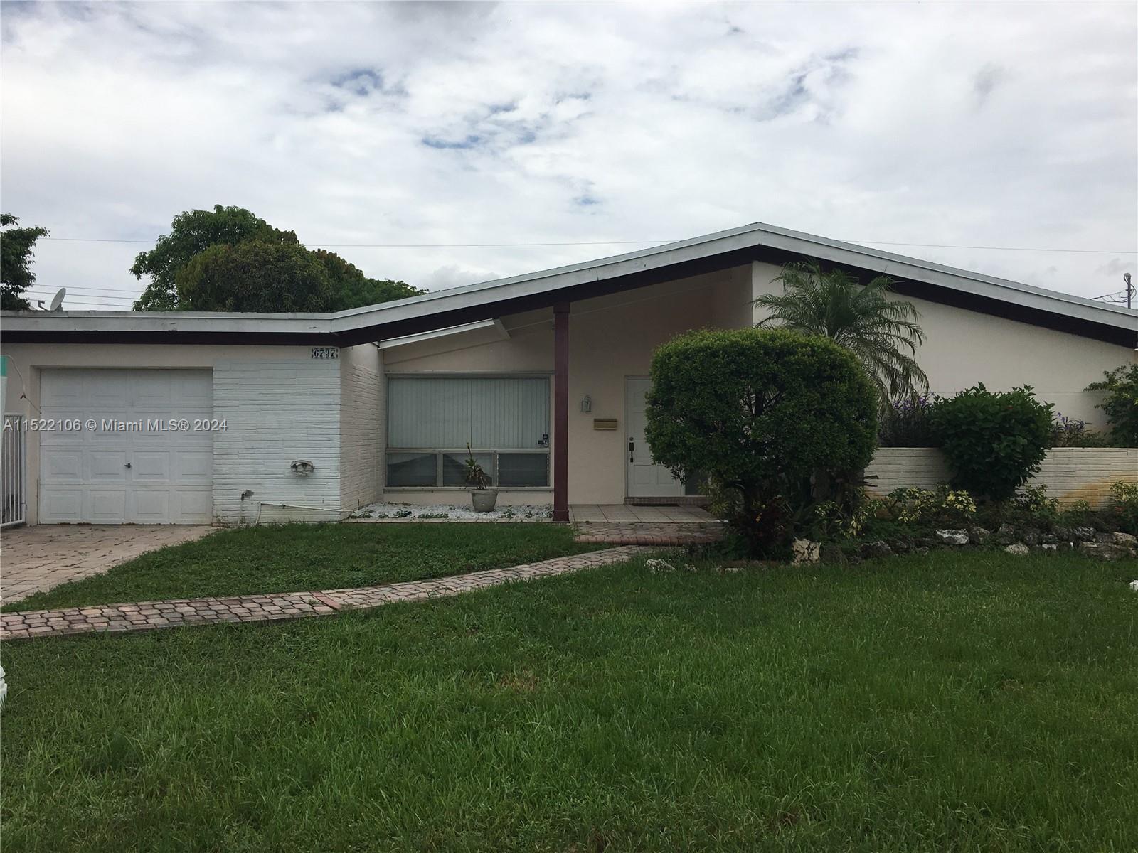 6737 Azalea Drive Miramar, FL 33023 - Photo 1 of 18 a backyard of a house with table and chairs