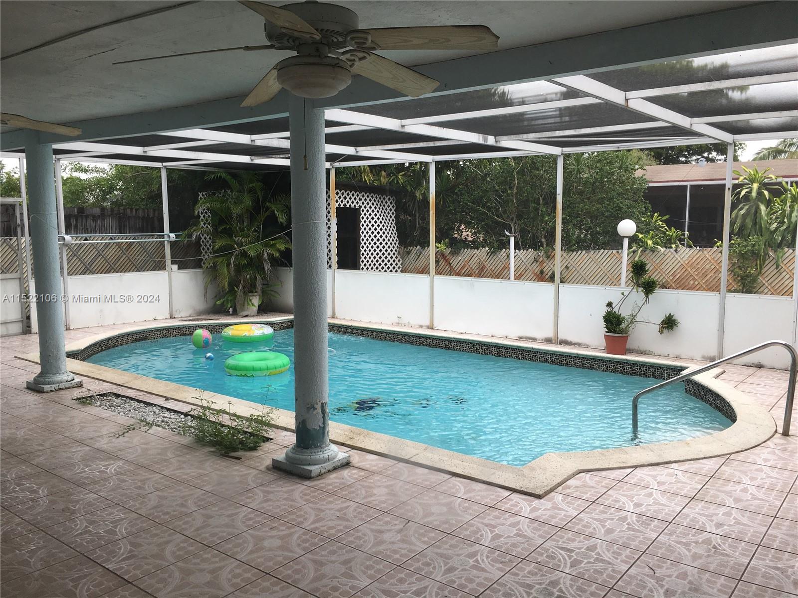 6737 Azalea Drive Miramar, FL 33023 - Photo 9 of 18 a view of a swimming pool with a porch